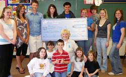 YAC presenting check to students